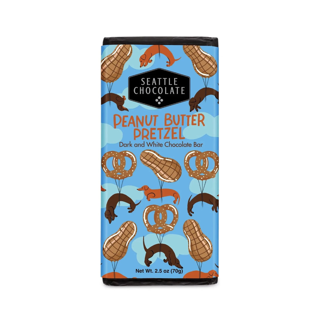 Seattle Chocolate Peanut Butter Pretzel, dark and white chocolate bar. 2.5 oz. Blue packaging with pretzels, peanuts, and dachshunds. 