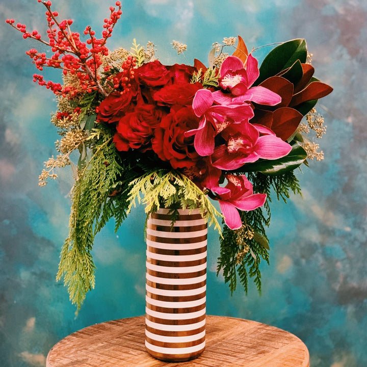 Dozen  roses with orchids in striped vase