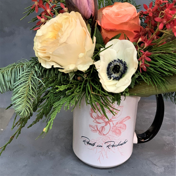 Close up of yellow rose and other florals in the arrangement.