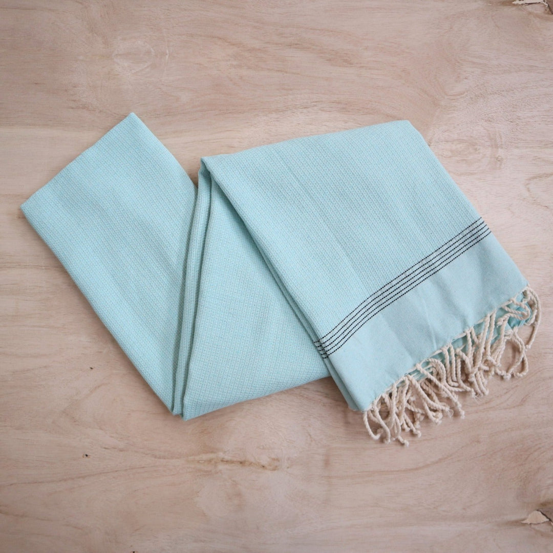 Turkish Scarves | Large light blue scarf. Can be used as a scarf, towel, or throw blanket! Light blue towel with cream tassels and five black stripes.